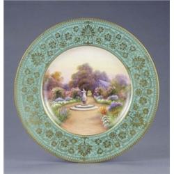 A Royal Worcester plate, with apple green and gilt floral scroll border, painted with a named vie...