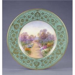 A Royal Worcester plate, with apple green and gilt floral scroll border, painted with a named vie...