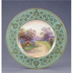 A Royal Worcester plate, with apple green and gilt floral scroll border, painted with a named vie...