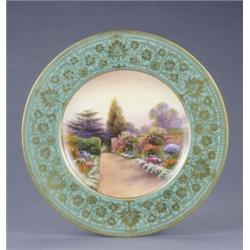 A Royal Worcester plate, with apple green and gilt floral scroll border, painted with a named vie...