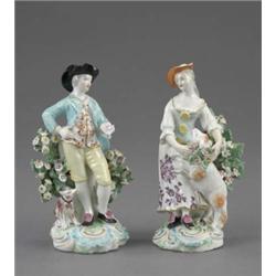 A pair of Derby figures of a shepherd and shepherdess, he wears a turquoise jacket and yellow bre...
