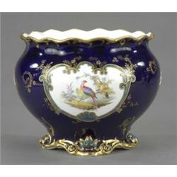 A Royal Crown Derby circular jardiniere, painted with two reserves of exotic birds in a landscape...