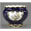 Image 1 : A Royal Crown Derby circular jardiniere, painted with two reserves of exotic birds in a landscape...