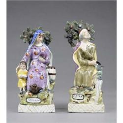 A pair of Staffordshire figures of Elijah and Widow, seated before flower encrusted branches, str...