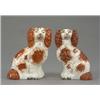 Image 1 : A small pair of Staffordshire figures of seated spaniels, with brown splashed coats, well detaile...