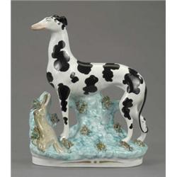 An unusual Staffordshire figure of a standing greyhound, with black splashed coat, the turquoise...