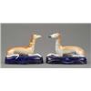 Image 1 : A pair of Staffordshire figures of resting greyhounds, with shaded tan coats and detailed muzzles...
