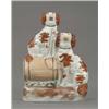 Image 1 : A Staffordshire group of two seated spaniels, with brown splashed coats, one seated on a barrel,...