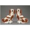 Image 1 : A pair of Staffordshire figures of seated spaniels, with brown splashed coats and bushy tails, bl...