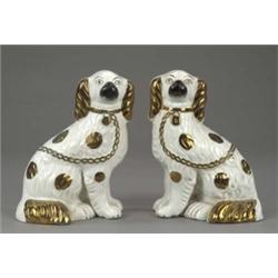 A pair of Staffordshire figures of seated spaniels, with copper lustre splashed coats, collars an...