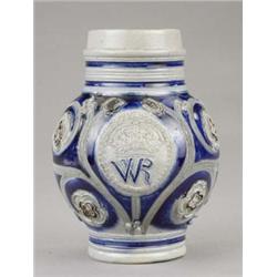A Westerwald stoneware jug, of bulbous form, moulded with crown and WR in an oval panel, moulded...