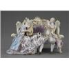Image 1 : A Meissen group of two musicians, seated on a sofa, he with flute and wearing yellow ground flora...