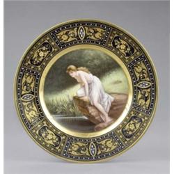 A Vienna plate, painted with 'Sylphida', on a rock overlooking a woodland pond, signed Fritsch, t...