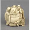 Image 1 : A Japanese ivory netsuke, carved as the smiling Hotei carrying a sack of figures on his back, sig...
