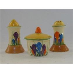 A CLARICE CLIFF BIZARRE CRUET SET, salt, pepper and mustard pot, 'Crocus' pattern, height of larg...