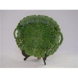 A TWIN HANDLED DESSERT PLATE, 19th Century, moulded leaf design, green majolica glaze, unmarked,...
