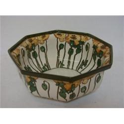 A ROYAL DOULTON FRUIT BOWL, early 20th Century, stylized yellow opium poppies on a white ground,...