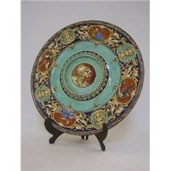 A CIRCULAR FAIENCE PLAQUE, late 19th Century, transfer printed and over-painted Renaissance decor...
