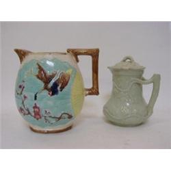 A MAJOLICA PITCHER, late 19th Century, moulded fan and stork design in the Aesthetic manner, turq...