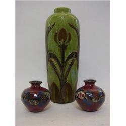 AN ART POTTERY BALUSTER VASE, early 20th Century, incised stylized plant motif on a green glaze g...