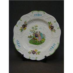 A MINTONS CREAMWARE PLATE, late 19th Century, moulded scrollwork border with over-enamelled trans...