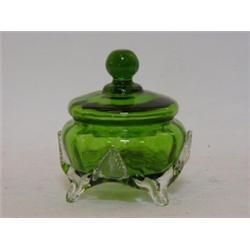 A BOTTLE GREEN GLASS COVERED BOWL, late Victorian, clear pincered foot and two pairs of clear gla...