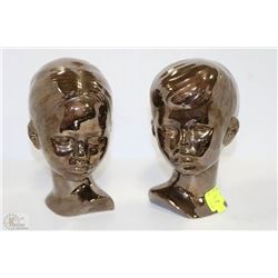 A PAIR OF BOY AND GIRL CERAMIC HEADS