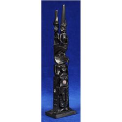 Haida Argillite Totem Carved with Eagle Transformation Figure Holding Human and Three Watchmen on To