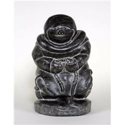 Inuit Soapstone Carving of an Inuk Holding a Rope Signed "Kananuk" 20572 From Puvirnituq 12" L. 7 1/