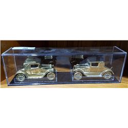 PAIR OF BRASS CARS IN CASE