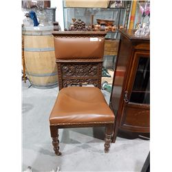HIGHLY CARVED OAK CHAIR W/LEATHER SEAT ON CASTERS