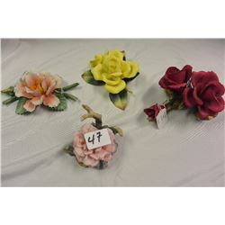 FOUR BISQUE FLORAL DECORATIONS