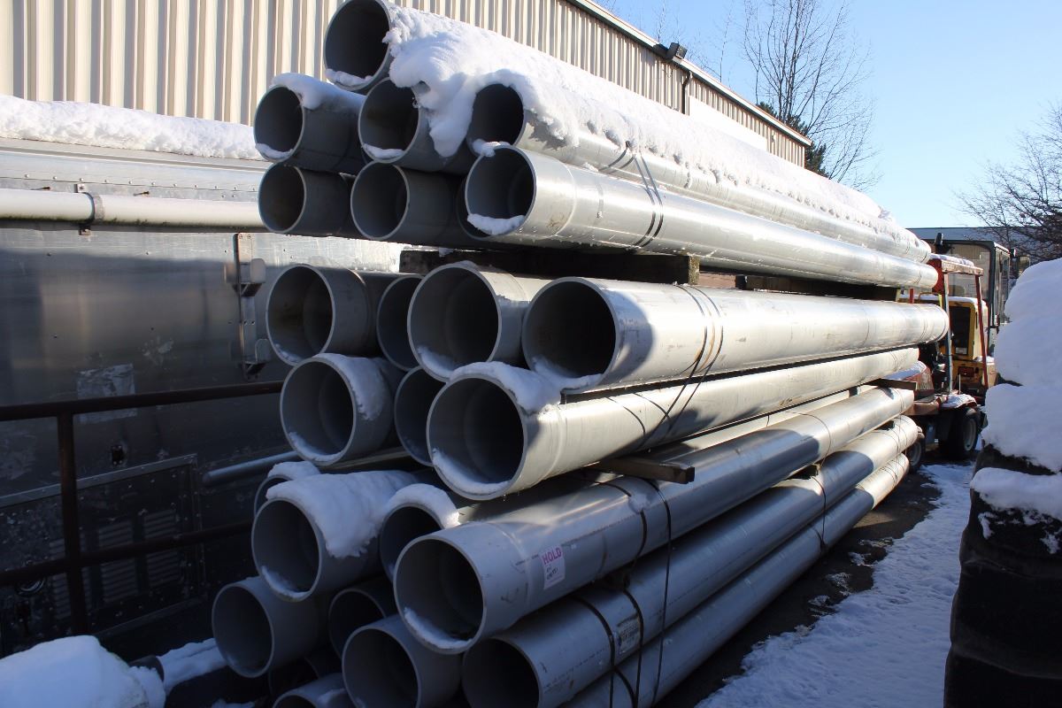 STACK OF LARGE PLASTIC WATER PIPE