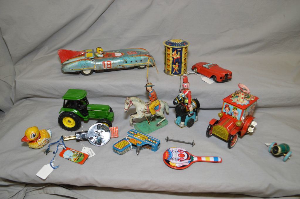Selection Of Vintage Wind Up And Tin Toys Including Tin Racer Clown Car A Trick Rider And A Toy So