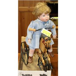 COLLECTIBLE DOLL ON HORSE TRICYCLE