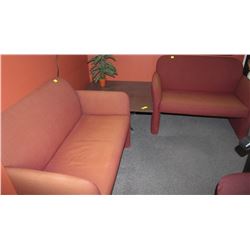 TWO RED LOVESEATS AND COFFEE TABLE