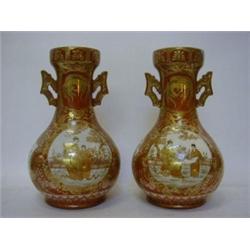 A PAIR OF KUTANI TWIN HANDLED VASES, late 19th Century, panels of exotic birds, figures and folia...