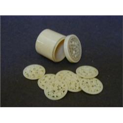 AN IVORY CYLINDRICAL COUNTER BOX, mid 19th Century, with nine pierced counters, height 4cm  50-80...