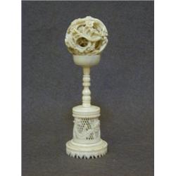 A CHINESE EXPORT IVORY PUZZLE BALL, late 19th Century, on stand, height 15cm (2)  70-90...