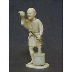 AN IVORY OKIMONO FIGURE, early 20th Century, man with bakset of fruit, base with red seal mark, h...