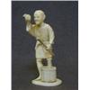 Image 1 : AN IVORY OKIMONO FIGURE, early 20th Century, man with bakset of fruit, base with red seal mark, h...