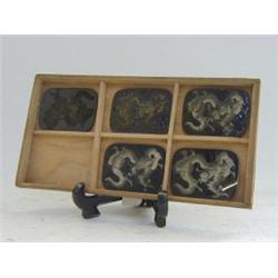 A CLOISONNE SAMPLE BOX, late 19th Century, showing five stages resulting in a coiled dragon, wood...