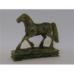 A GREEN SOAPSTONE FIGURE, 20th Century, trotting horse, rectangular plinth, height 16cm  20-30...