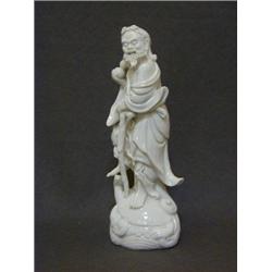 A BLANC DE CHINE FIGURE, late 19th Century or early 20th Century, bearded gentleman with stick an...