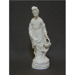 A BLANC DE CHINE FIGURE, 20th Century, oriental maiden carrying a fish in a basket, height 26cm,...