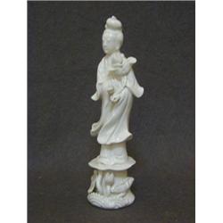 A BLANC DE CHINE FIGURE, 20th Century, oriental maiden carrying a flower, height 20cm  20-30...