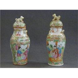 A PAIR OF MINIATURE BALUSTER VASES, and covers, late 19th Century, famille rose figure decoration...