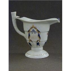 A HELMET SHAPED PITCHER, Chinese armorial export, c.1800, the design a heater shaped shield under...