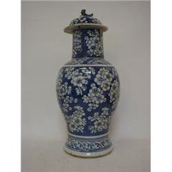 AN ORIENTAL EXPORT BALUSTER JAR AND COVER, prunus decorated on a deep blue ground (damages), heig...