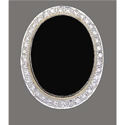 BLACK ONYX AND DIAMOND RING, Centered by a 25 by 18.2 mm cabochon onyx, surrounded by thirty-ei...